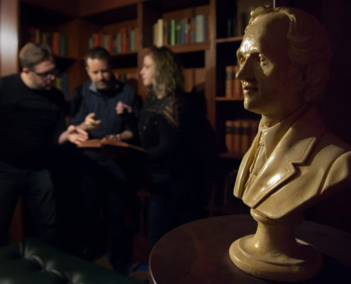 Players exploring the hidden library of The Storykeeper escape room