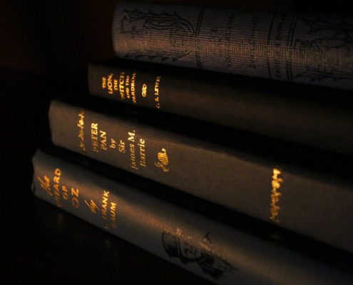 A stack of vintage books inside The Storykeeper